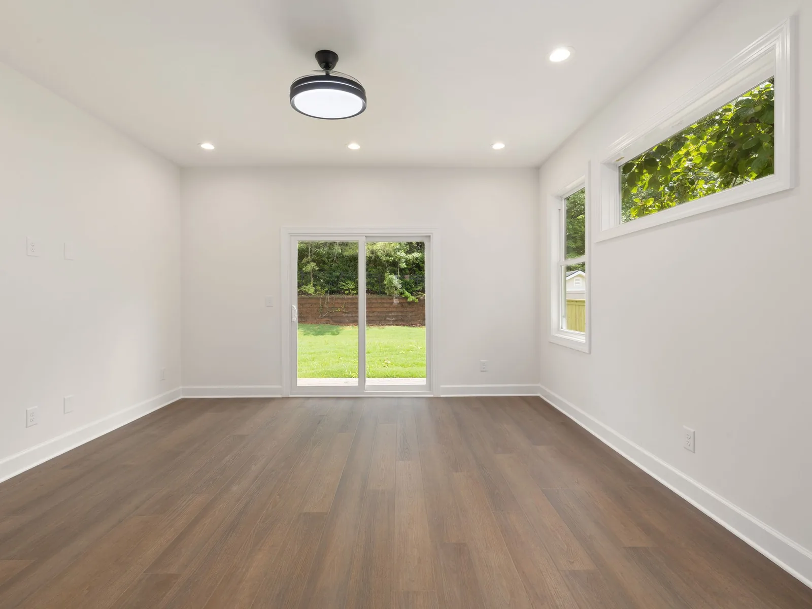 Freshly painted empty room with a wooden floor