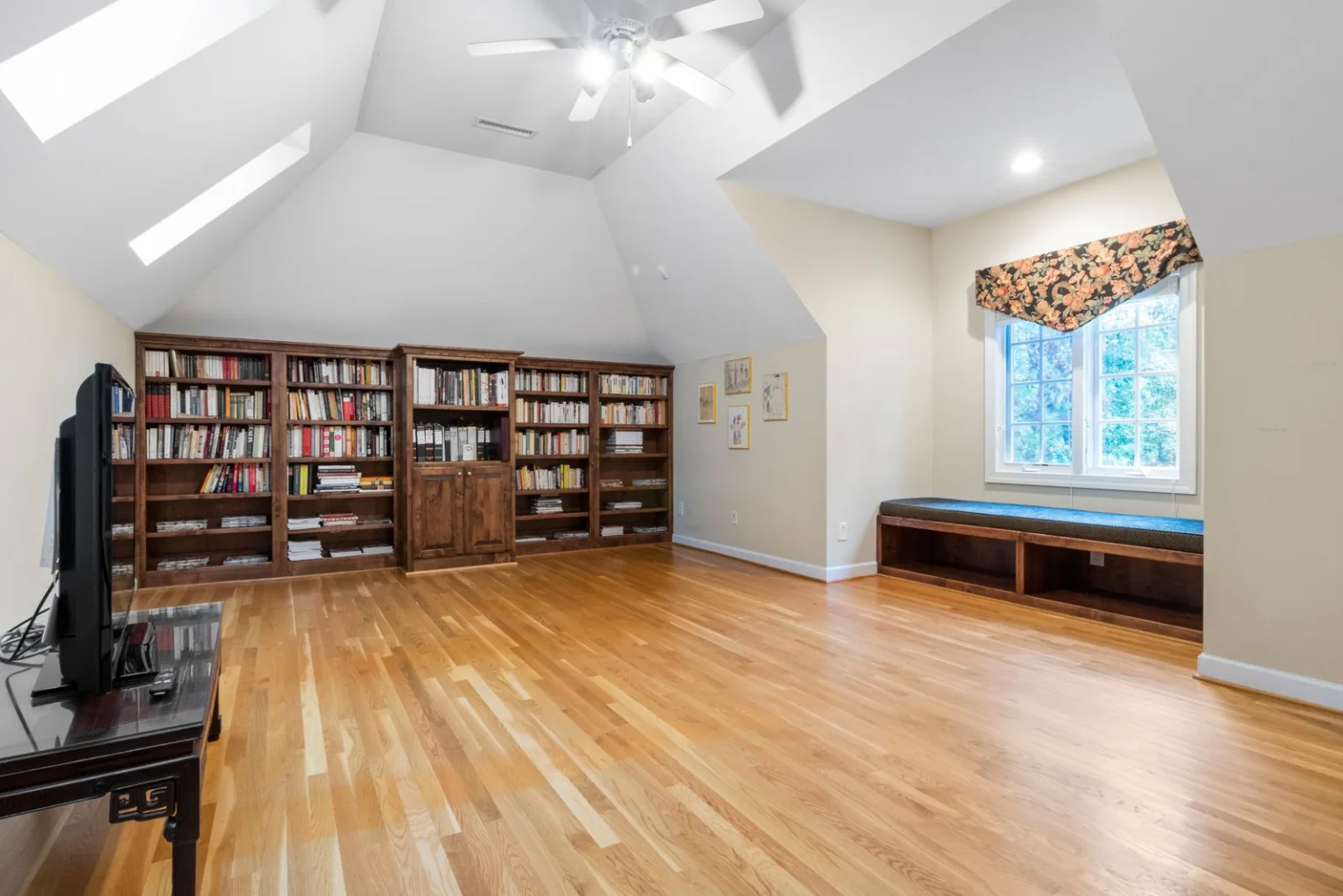 Wooden bookcase wall under the sloping roof