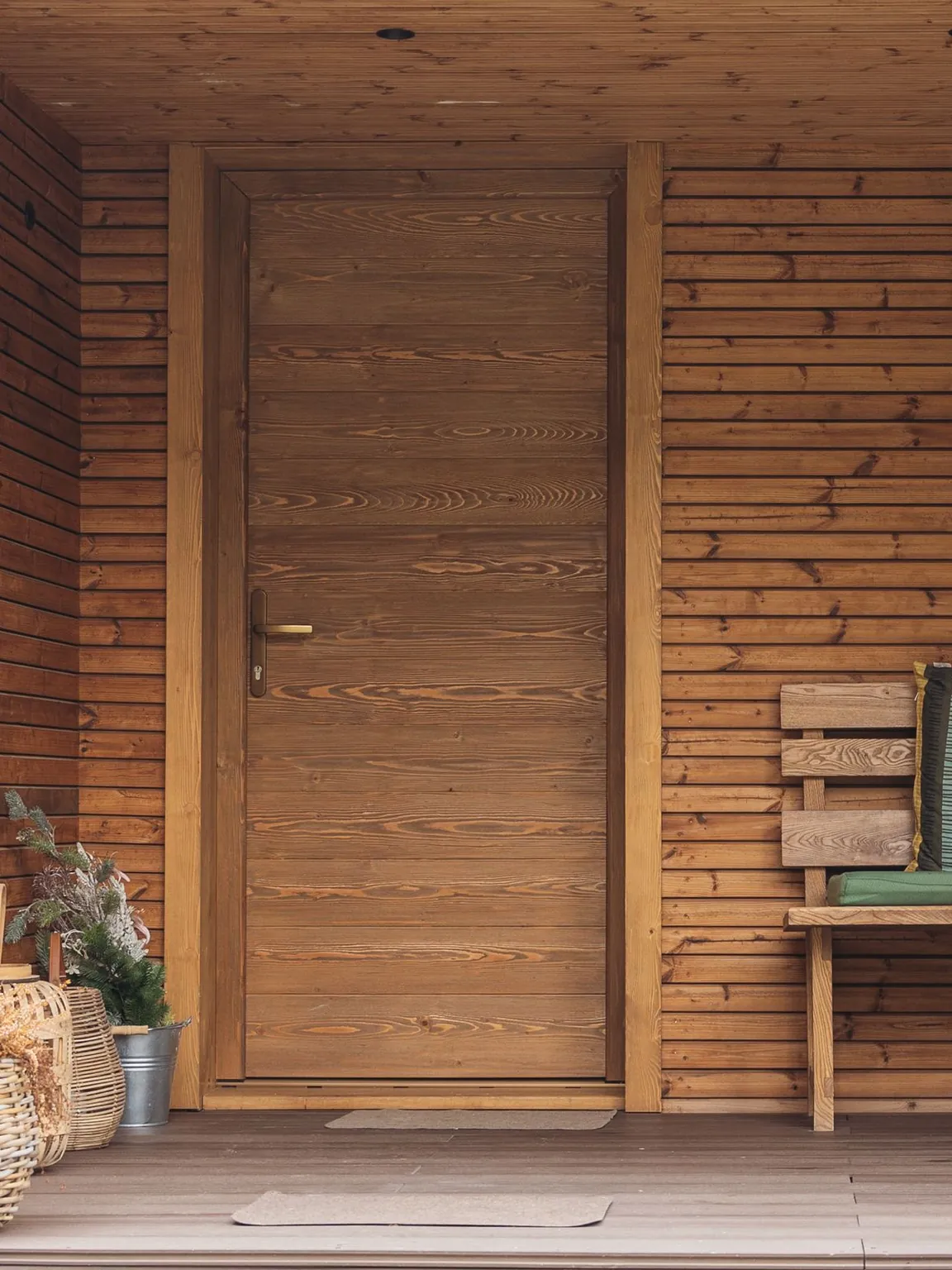Wooden front door in a covered entrance