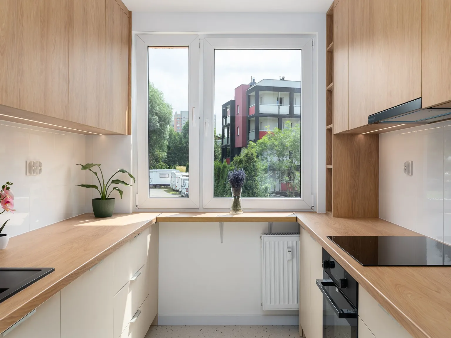 Single-run kitchen with light wooden fronts
